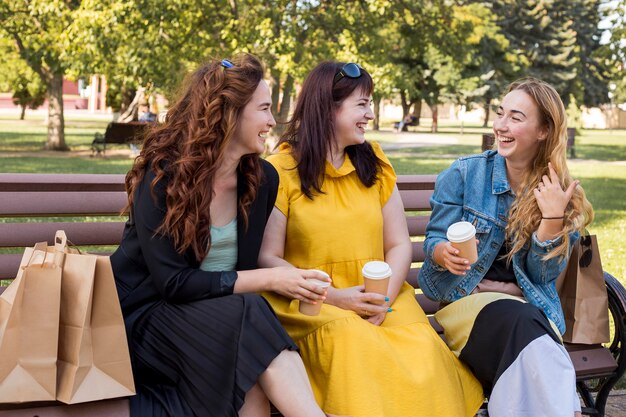 Best friends chatting while sitting on a bench