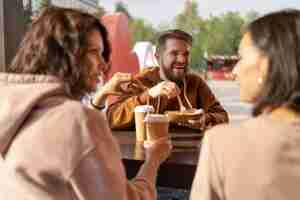 Free photo best friends eating street food