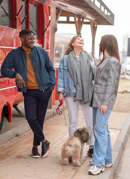 Free photo best friends getting something from a food truck