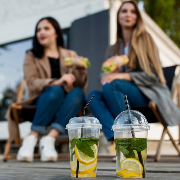 Best friends hanging out outside with some cocktails