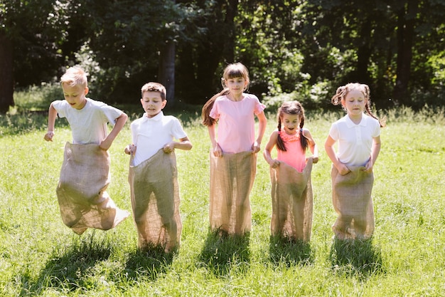 Free photo best friends having fun in burlap bags