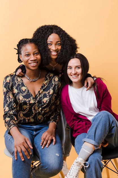 Best friends posing together in a studio