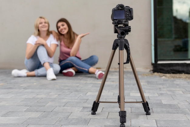 Best friends taking a photo together with a camera