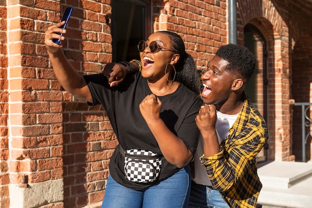 Best friends taking a selfie together outside