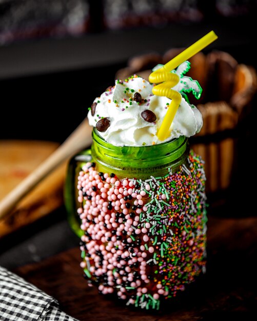 Beverage topped with whipped cream and candies