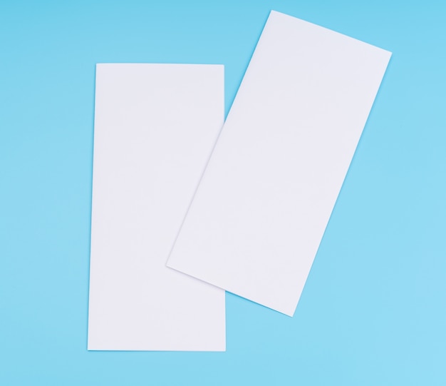 Bifold white template paper on blue background .