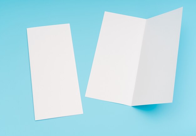 Bifold white template paper on blue background .