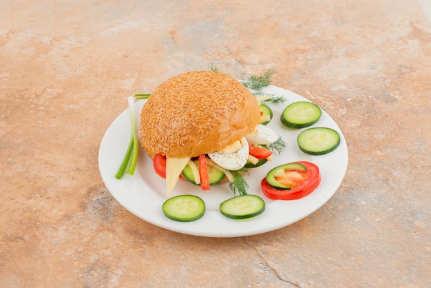 Free photo big burger with cucumber and egg .