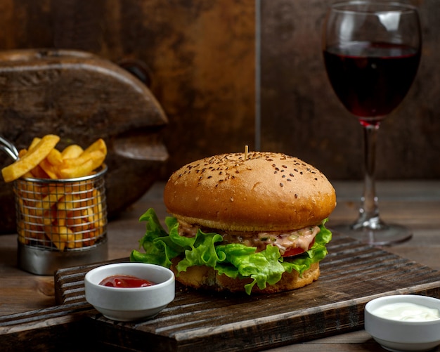 Big burger with soft bun and french fries