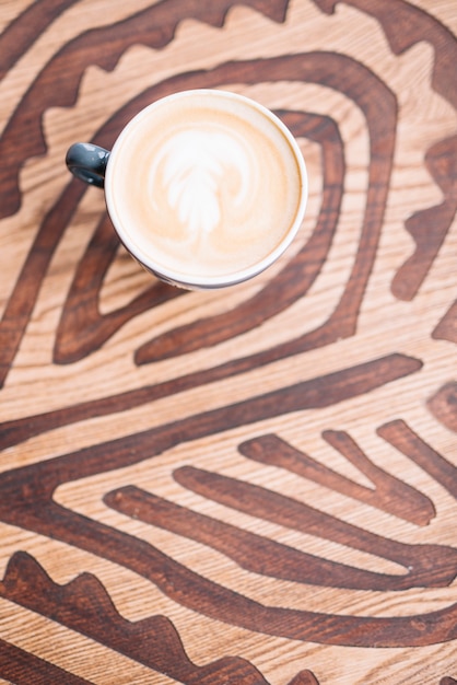 Big coffee cup on wooden table