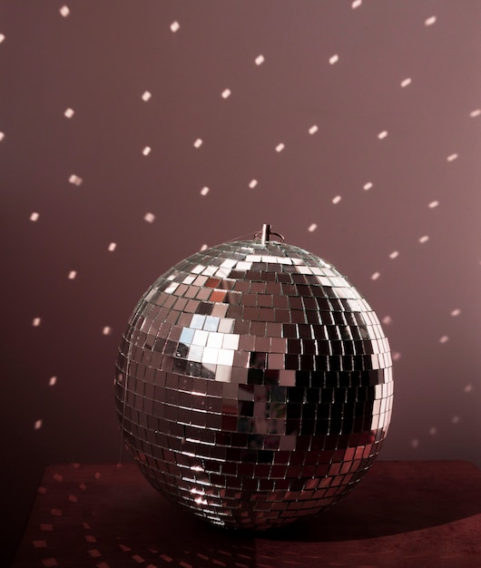 Free photo big disco ball on brown floor with lights