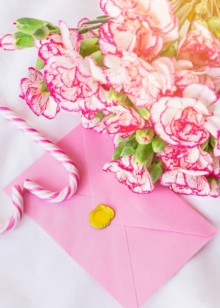 Big flowers bouquet with bright envelope on table