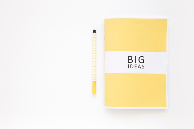 Big ideas diary with pen on white background