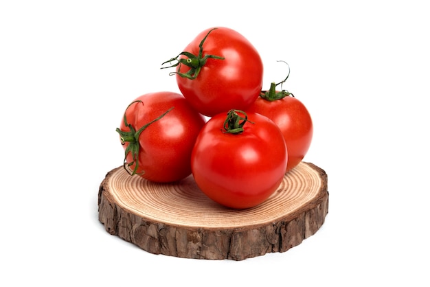 Big red fresh tomatoes on a wooden board.