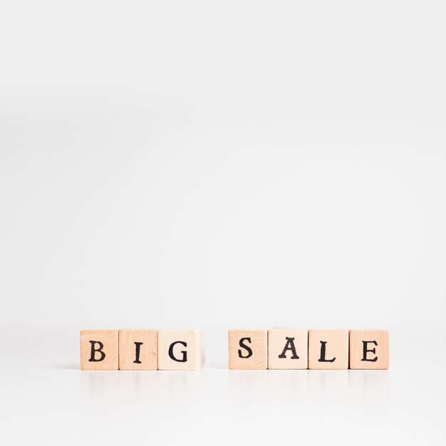 Big sale inscription on wooden blocks on table 