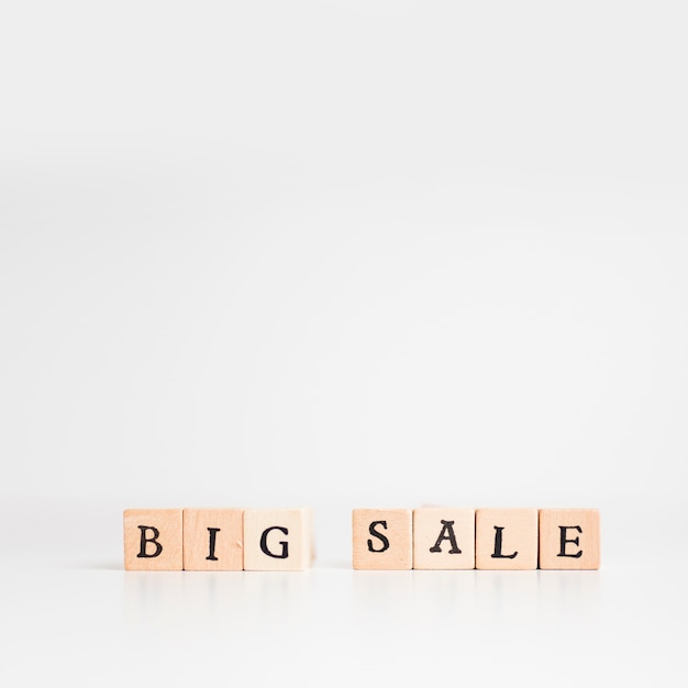 Big sale inscription on wooden blocks on table 