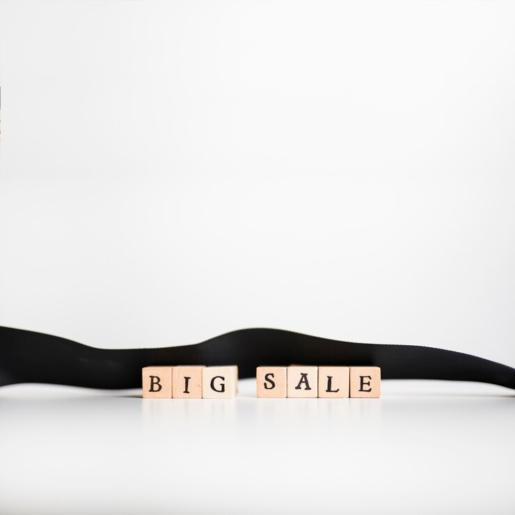 Free Photo big sale inscription on wooden blocks with ribbon 