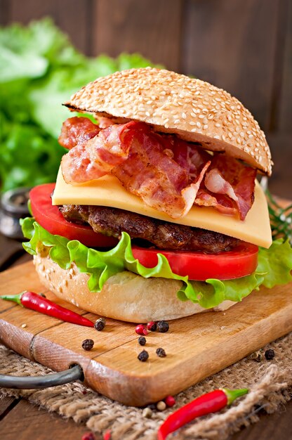 Big sandwich - hamburger burger with beef, cheese, tomato and fried bacon