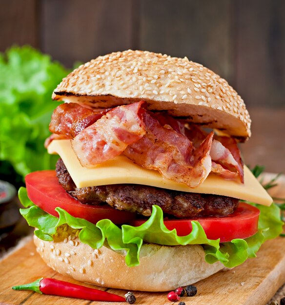 Big sandwich - hamburger burger with beef, cheese, tomato and fried bacon