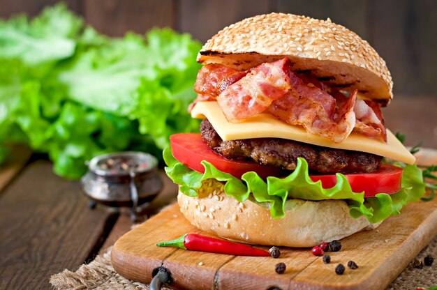 Big sandwich - hamburger burger with beef, cheese, tomato and fried bacon