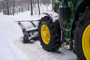 Free photo big special tractor is removing snow from the forestal road.