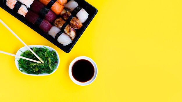 Big sushi plate with seaweed salad and soy sauce