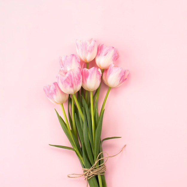 Big tulips bouquet on pink table