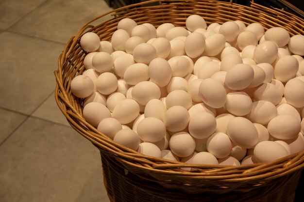 Free photo big wicker basket with eggs in supermarket