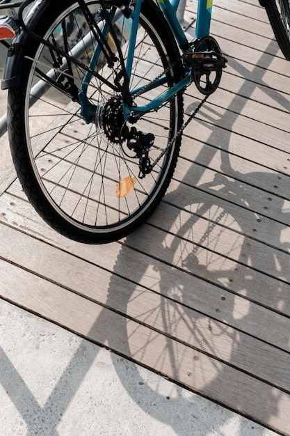 Free photo bike on wood and its shadows