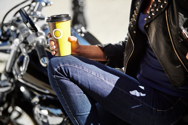 Biker girl in a leather jacket on a motorcycle