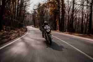 Free photo biking a motorcycle in the forest.