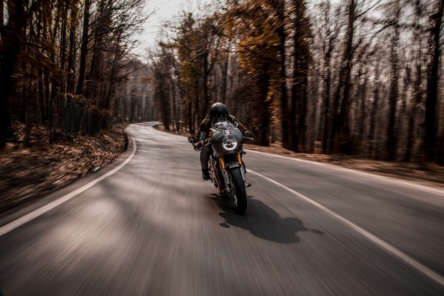 Biking a motorcycle in the forest.