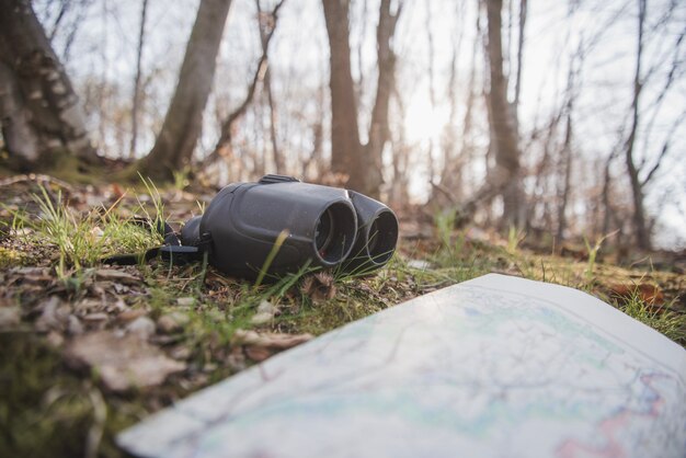 Binoculars and map on the ground