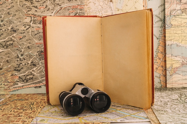 Binoculars near opened notebook