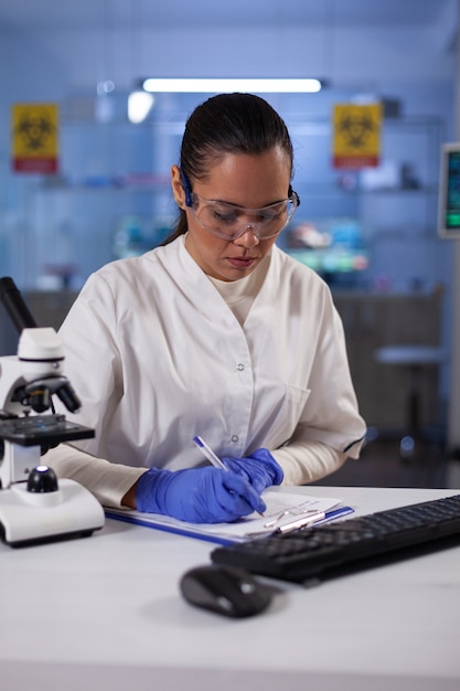 Foto gratuita donna ricercatrice biologa che lavora all'esperimento di microbiologia