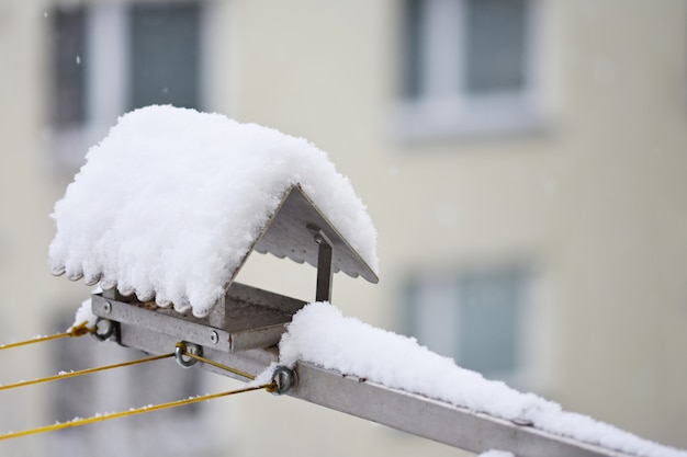 Bird feeder in winter with snow.