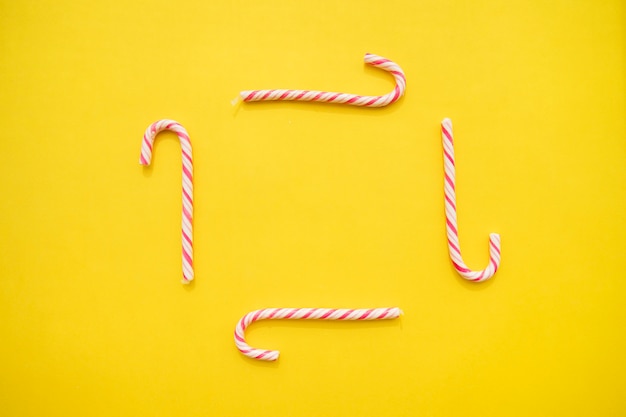 Free photo birthday background with frame made of candy canes