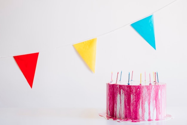 Free photo birthday cake and colorful pennants