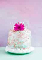 Free photo birthday cake in front of watercolor background