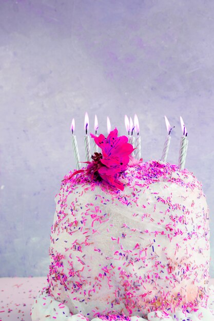 Birthday cake in front of watercolor background