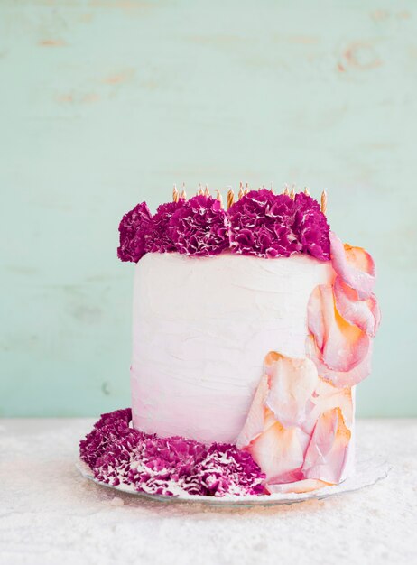 Birthday cake in front of watercolor background