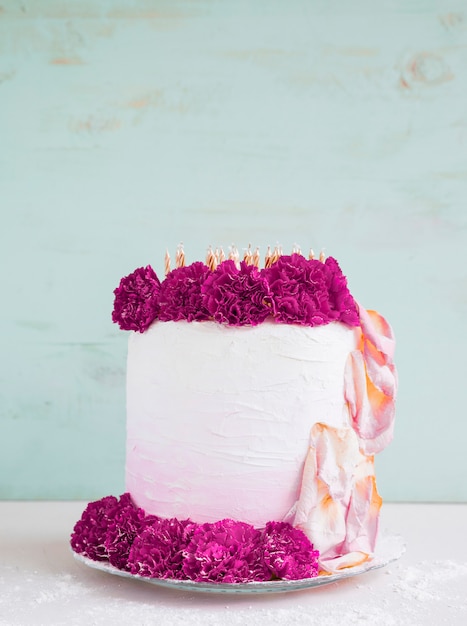 Birthday cake in front of watercolor background