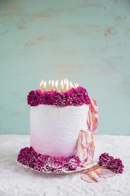 Free photo birthday cake in front of watercolor background