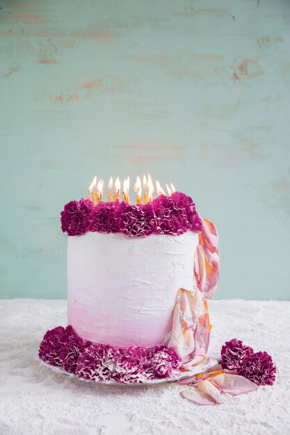 Birthday cake in front of watercolor background