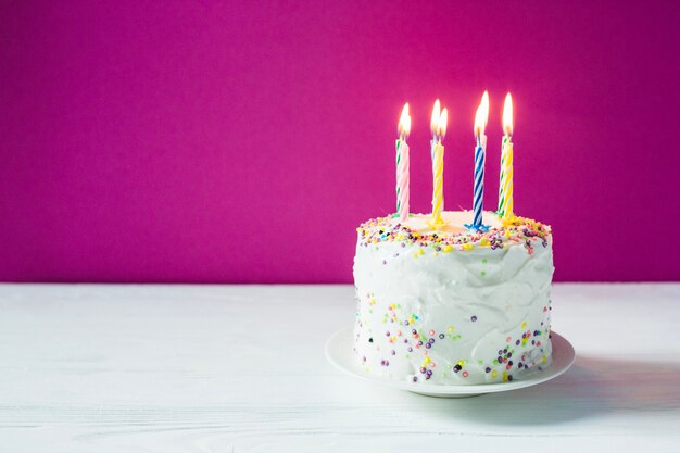 Birthday cake with candles on plate