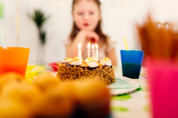 Birthday cake with candles on table