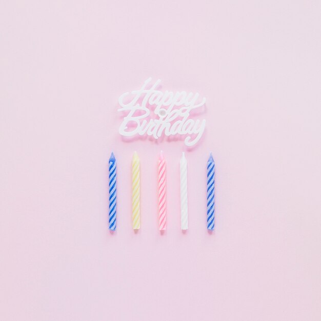 birthday candles lying near writing