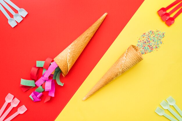 birthday composition with decorative ice cream cones and plastic spoons