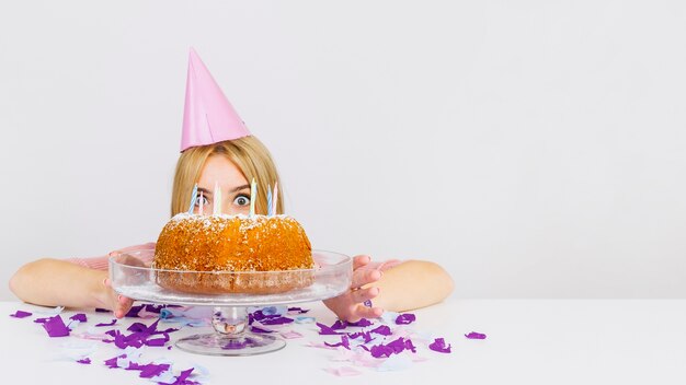Концепция дня рождения с лицом женщины после торта