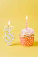 Free photo birthday cupcake with lit candle